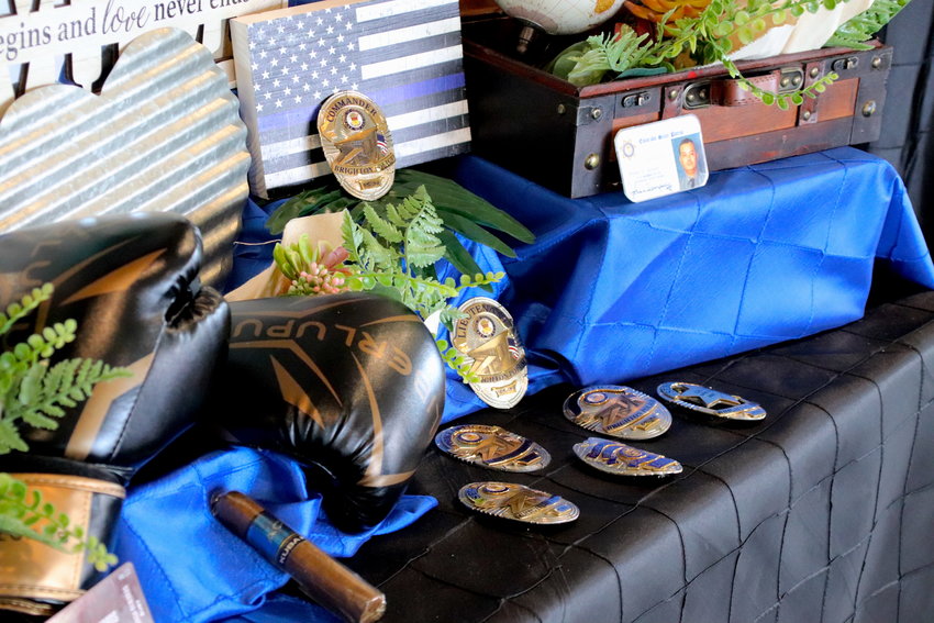 A display meant to help illustrate the life and career of Brighton police Cmdr. Frank Acosta includes the various badges he wore during his career.